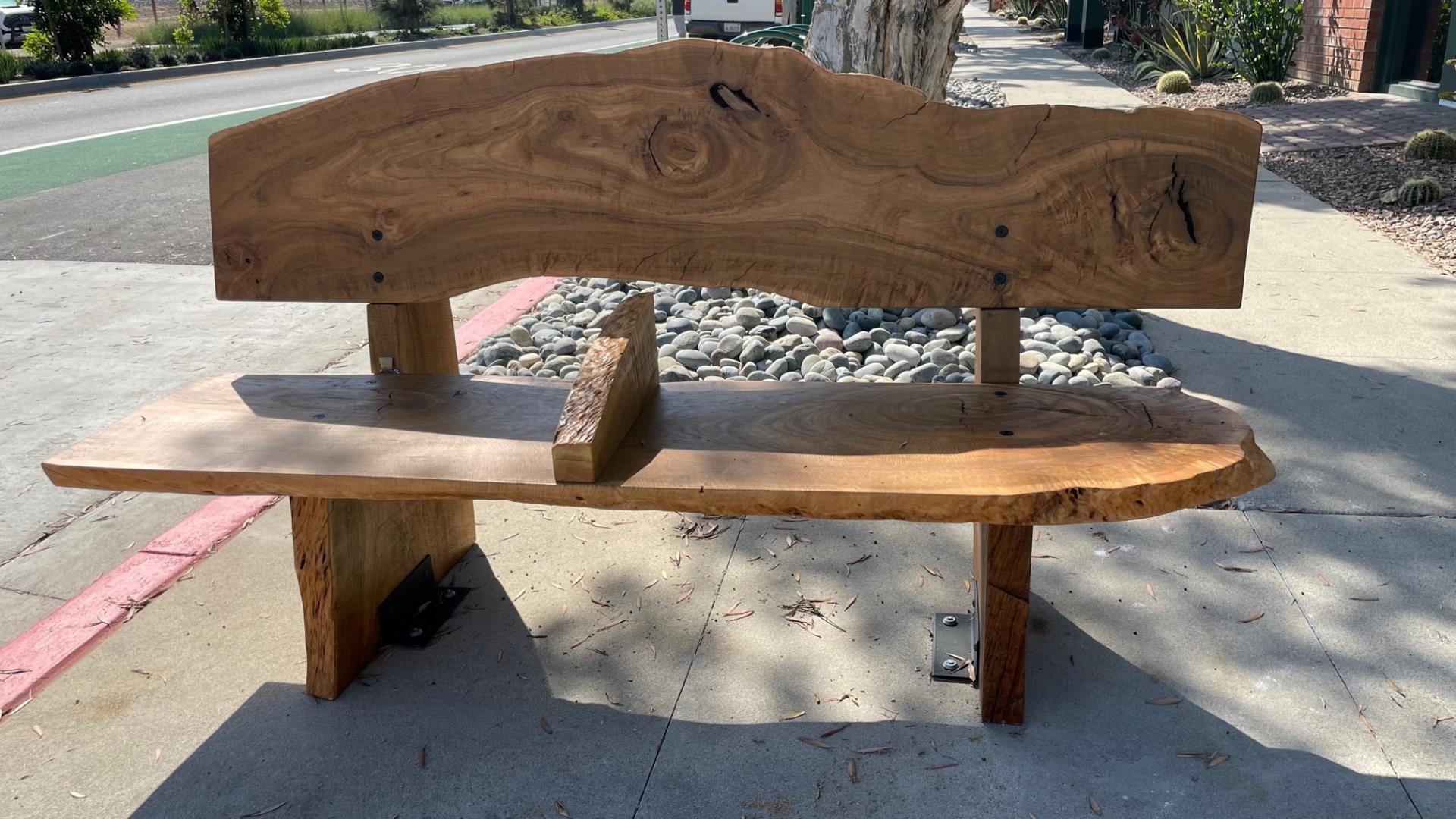 wooden bench on sidewalk