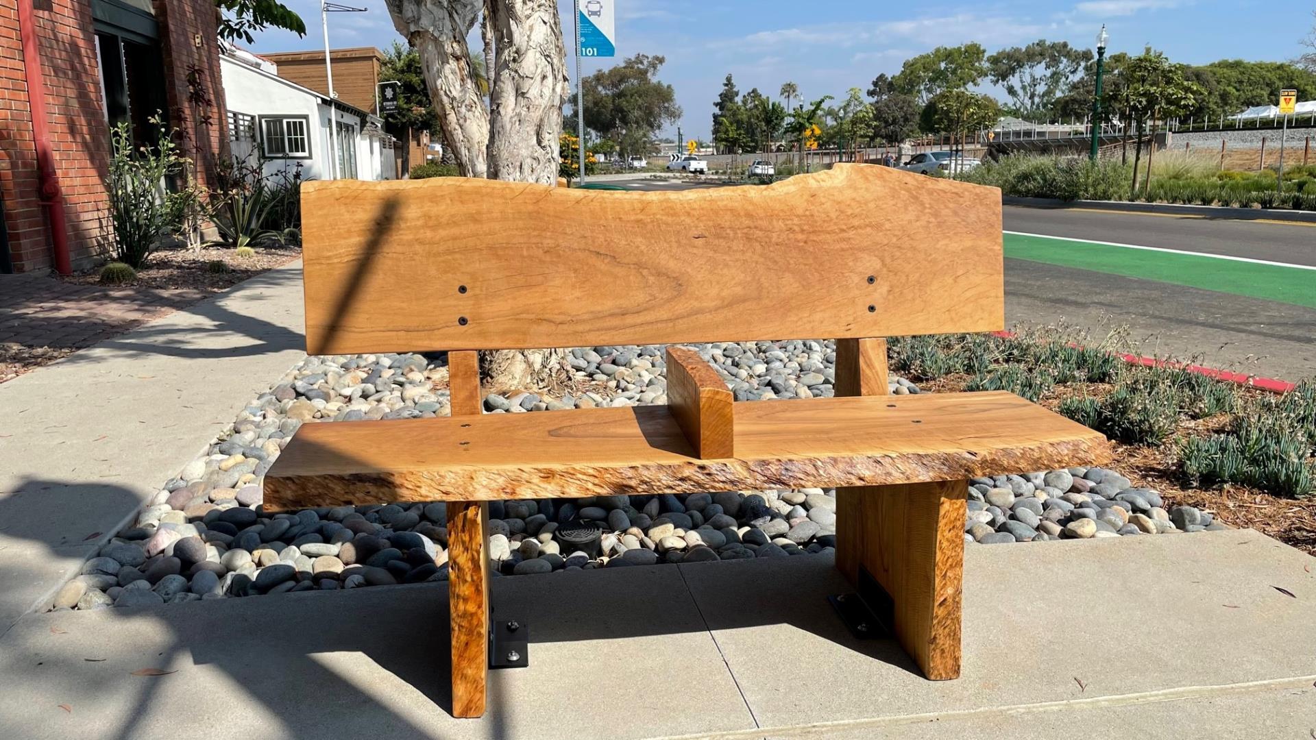 wooden bench on sidewalk