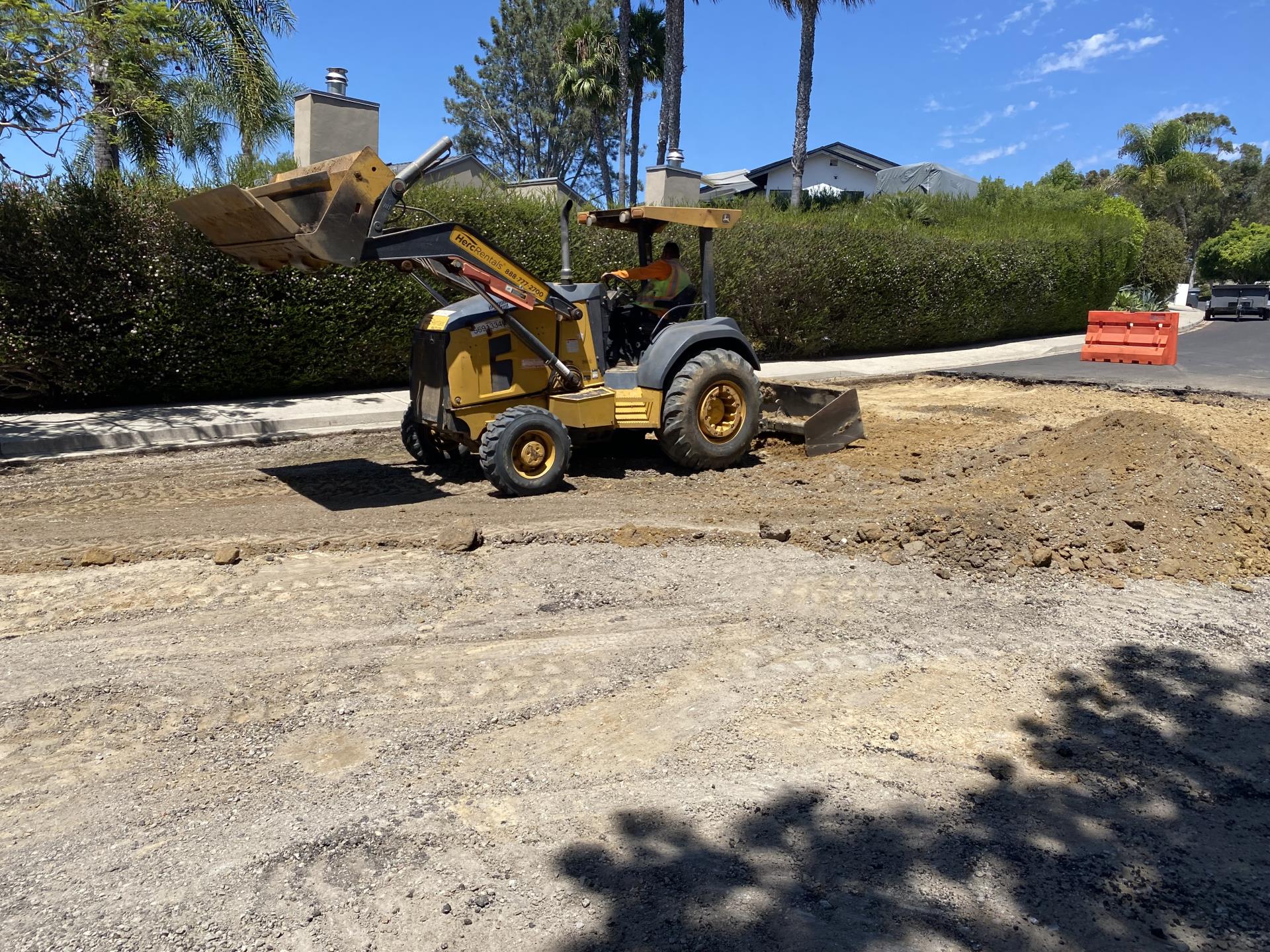 Image of construction equipment removing and Scarcifying soil for 10 inch section