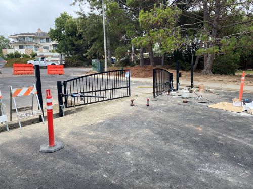 Construction progress photo showing newly installed gate and construction debris