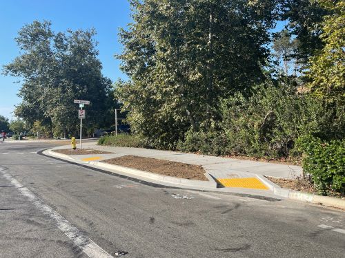 newly constructed sidewalk and curb ramp on Quail Gardens Drive