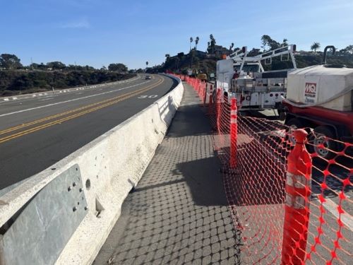 Image of krail barrier pedestrian path and construction zone fencing along S.Hwy 101 looking south