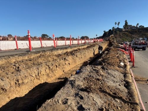 Image of excavation and trench for retaining wall next to S. Hwy 101 looking south